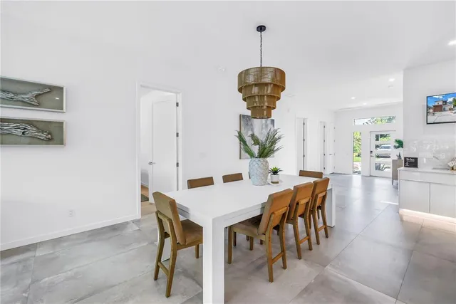 a kitchen with stainless steel appliances a stove a sink a chimney and a refrigerator