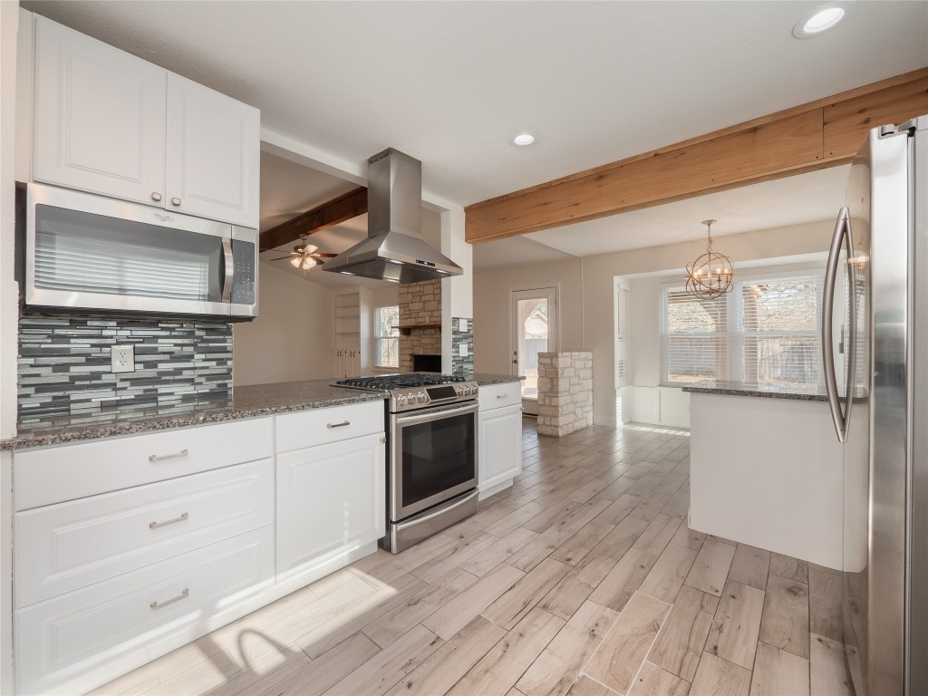 3209 Buffalo Springs Trail Georgetown, TX 78628 - Photo 12 of 32 a kitchen with granite countertop white cabinets and white appliances