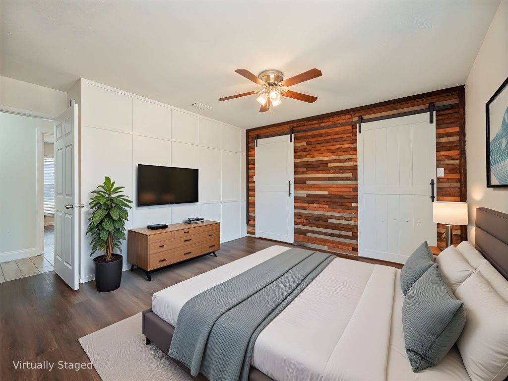 3209 Buffalo Springs Trail Georgetown, TX 78628 - Photo 13 of 32 a bedroom with a bed a couch and a flat screen tv