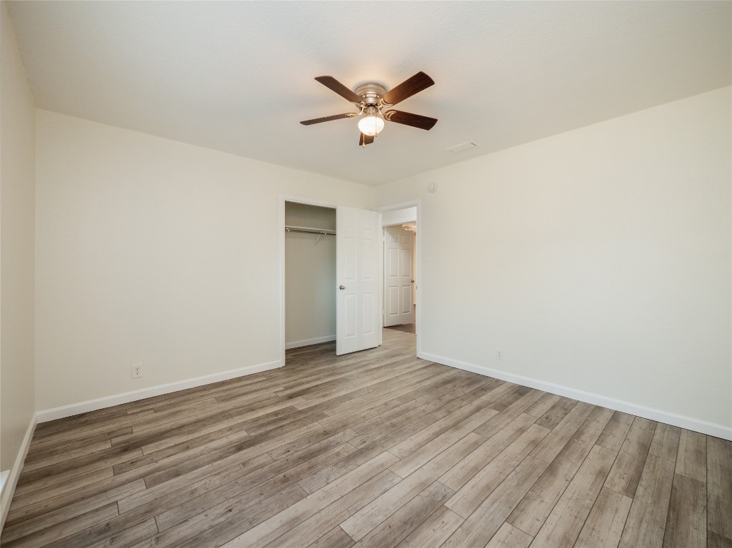 3209 Buffalo Springs Trail Georgetown, TX 78628 - Photo 19 of 32 a view of an empty room with wooden floor and a ceiling fan