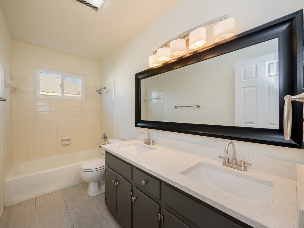 3209 Buffalo Springs Trail Georgetown, TX 78628 - Photo 20 of 32 a bathroom with a sink a toilet and a large mirror