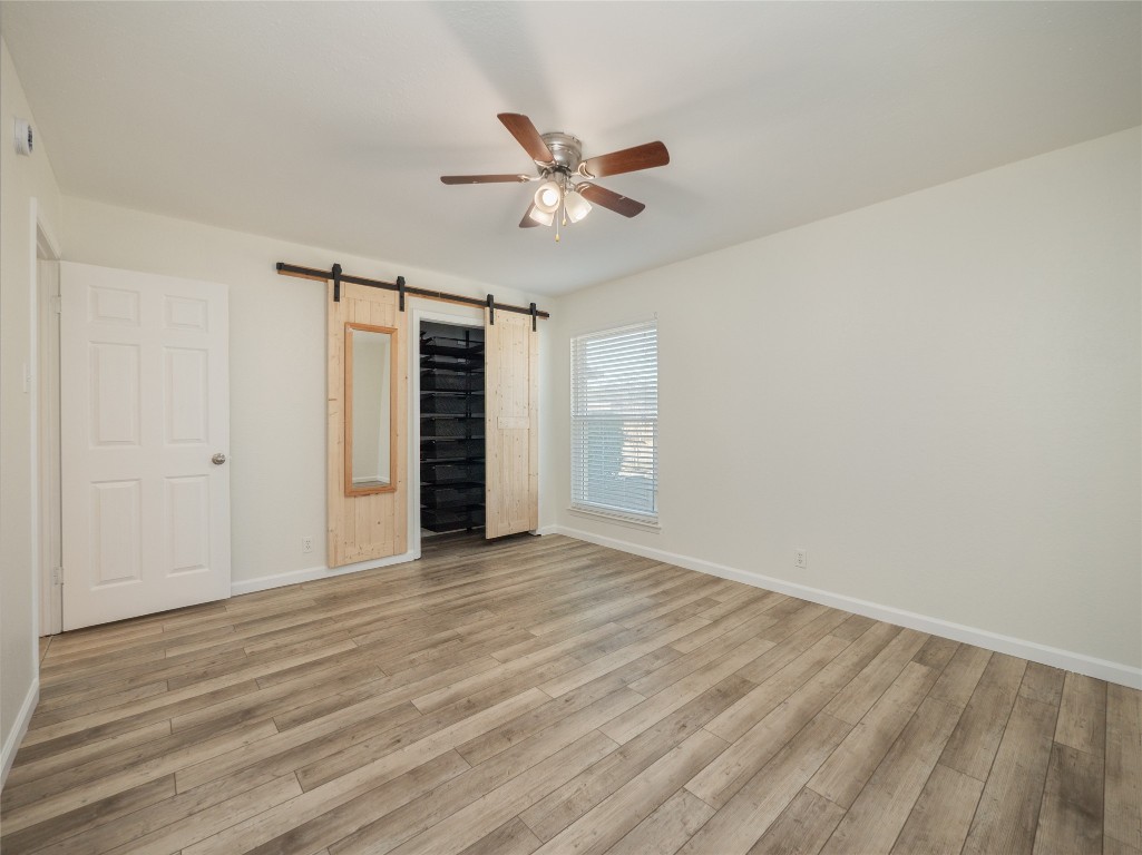 3209 Buffalo Springs Trail Georgetown, TX 78628 - Photo 22 of 32 a view of empty room with wooden floor and ceiling fan