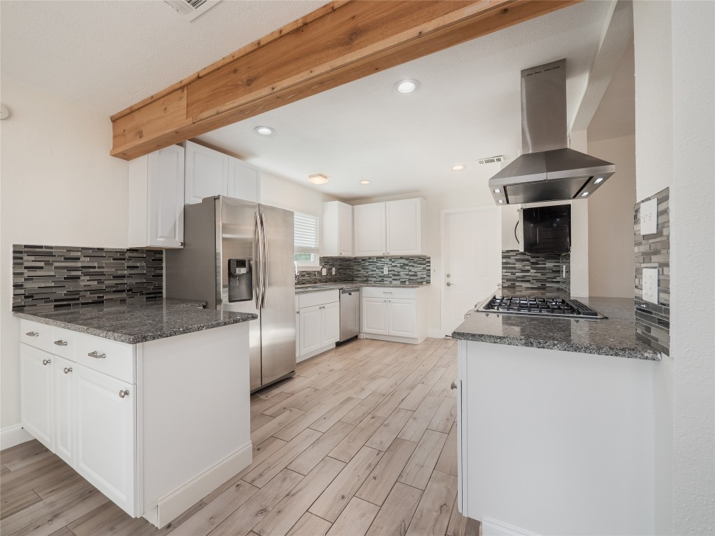 3209 Buffalo Springs Trail Georgetown, TX 78628 - Photo 9 of 32 a kitchen with stainless steel appliances kitchen island granite countertop a stove and a refrigerator