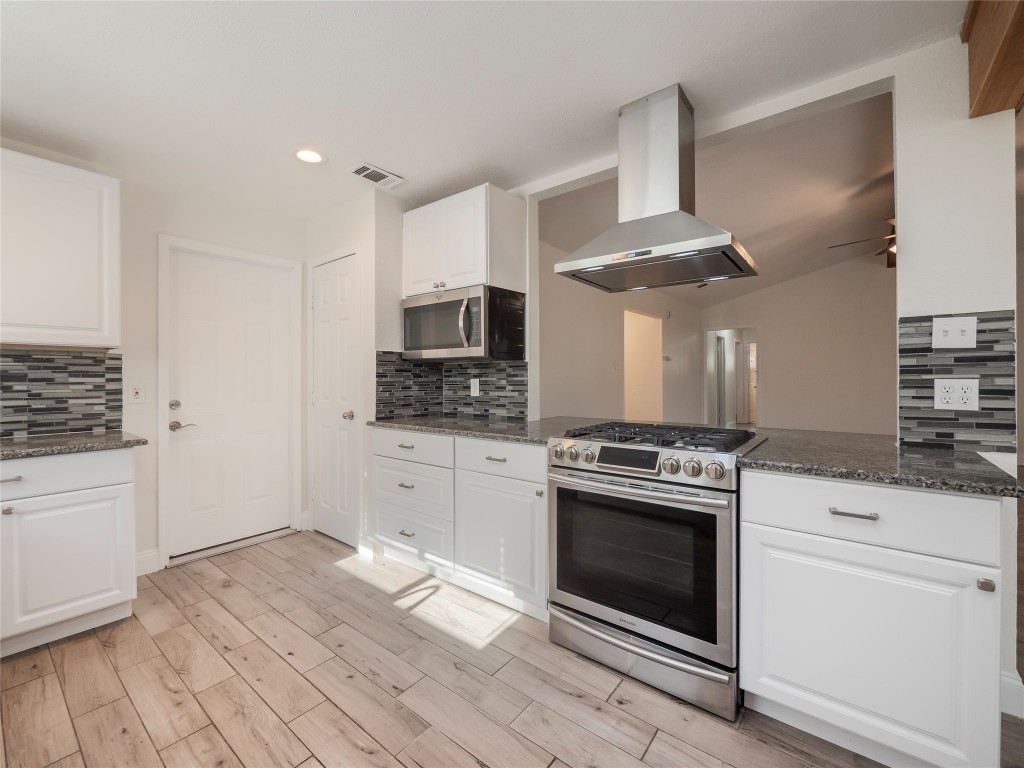 3209 Buffalo Springs Trail Georgetown, TX 78628 - Photo 10 of 32 a kitchen with stainless steel appliances white cabinets a sink a stove a refrigerator and white cabinets