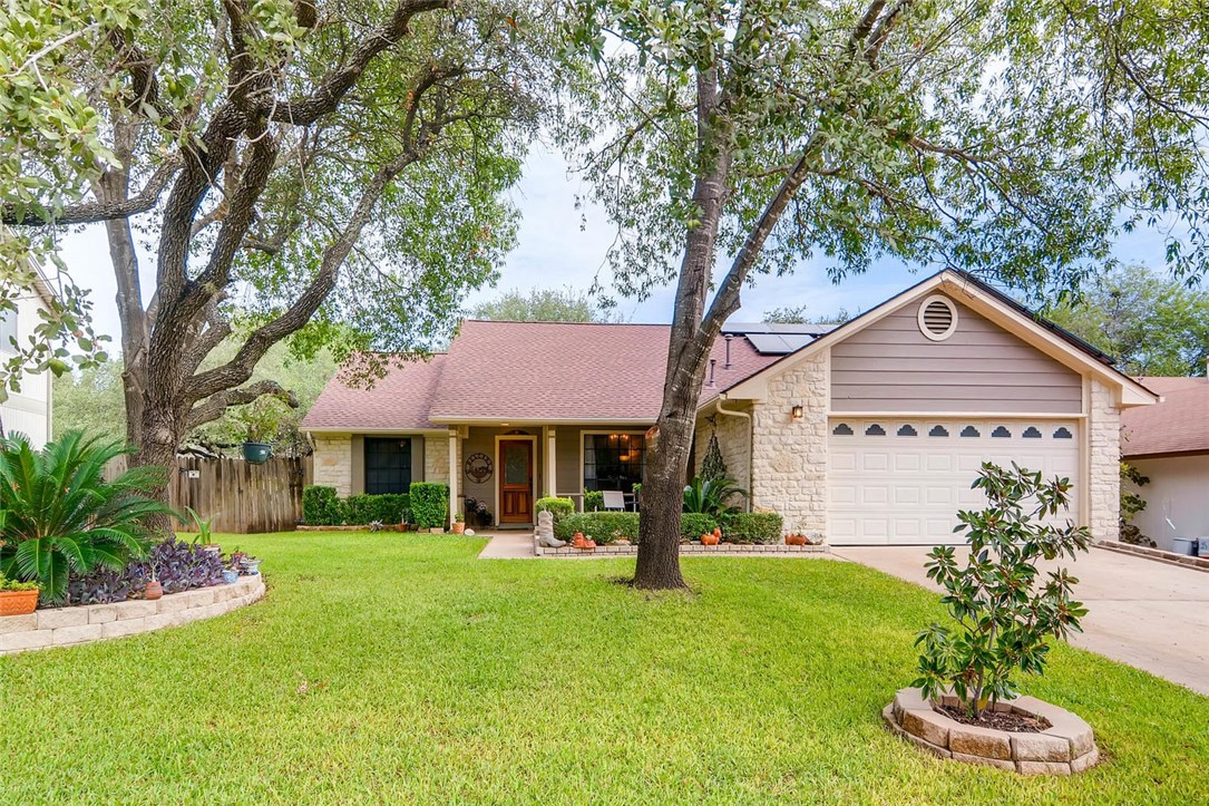 1504 Elvas Way Austin, TX 78758 - Photo 1 of 1 a front view of a house with a yard and garage