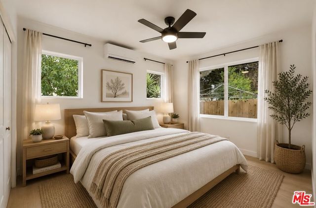 a bedroom with a large bed and a window