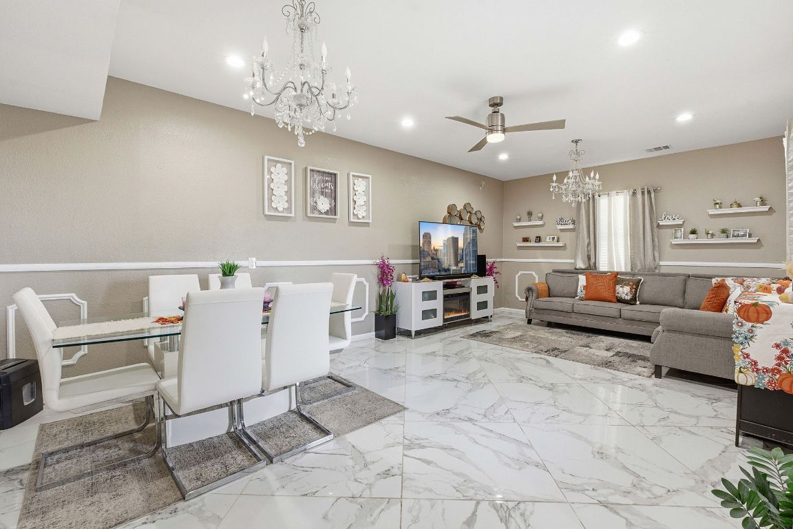 169 Ridgetop Road Buda, TX 78610 - Photo 11 of 40 a living room with furniture and a chandelier