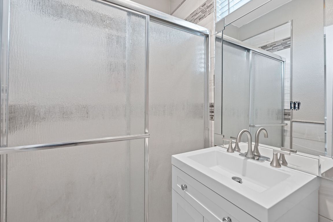 169 Ridgetop Road Buda, TX 78610 - Photo 13 of 40 a bathroom with a sink and mirror