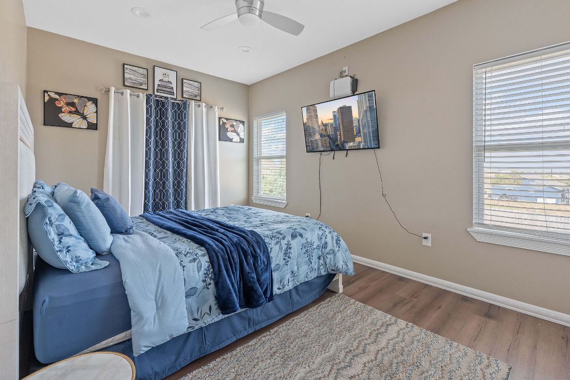 169 Ridgetop Road Buda, TX 78610 - Photo 14 of 40 a bedroom with a large bed and a window