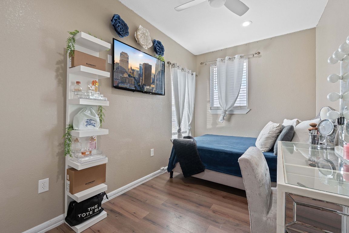 169 Ridgetop Road Buda, TX 78610 - Photo 17 of 40 a bedroom with furniture and a window