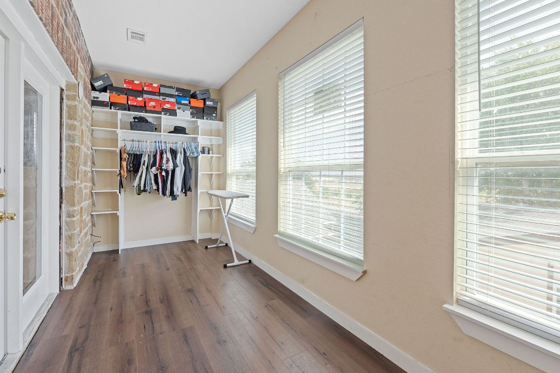 169 Ridgetop Road Buda, TX 78610 - Photo 20 of 40 a view of a room with wooden floor and a window