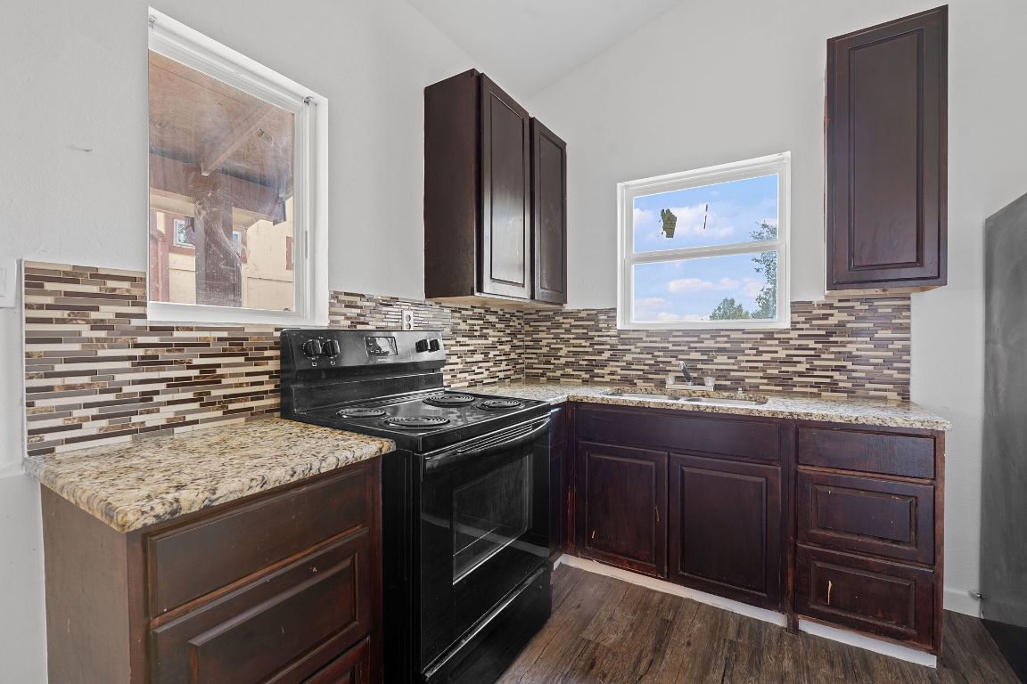 169 Ridgetop Road Buda, TX 78610 - Photo 25 of 40 a kitchen with granite countertop stainless steel appliances and wooden cabinets