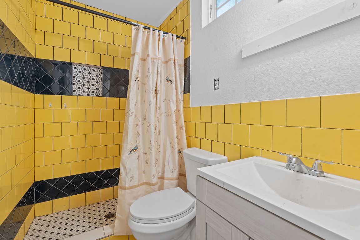 169 Ridgetop Road Buda, TX 78610 - Photo 29 of 40 a bathroom with a sink a toilet and shower