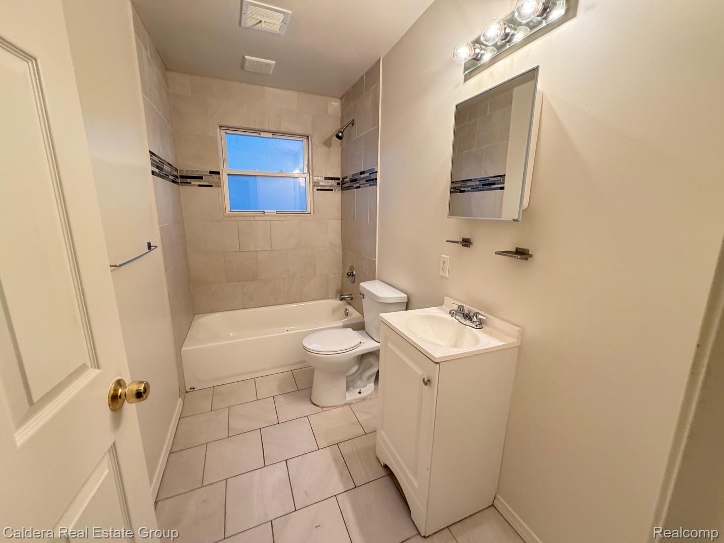 15354 Lahser Road Detroit, MI 48223 - Photo 8 of 10 Full bathroom featuring vanity, light tile patterned floors, and shower / bathtub combination