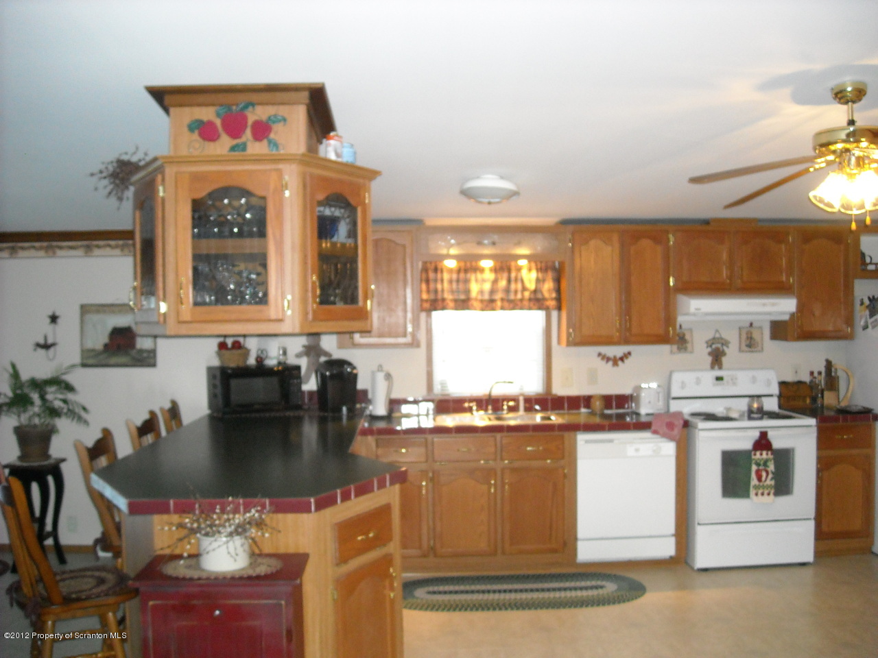 1649 Oak Ridge Road Mehoopany, PA 18629 - Photo 4 of 13 a kitchen with a stove top oven and cabinets