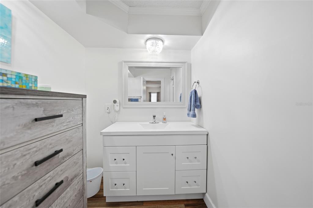 10303 Burnt Store Road, Unit 143 Punta Gorda, FL 33950 - Photo 14 of 42 a bathroom with a sink vanity and mirror