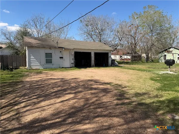 a view of a house with a yard and garage