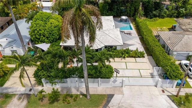 an aerial view of a house with a yard and potted plants