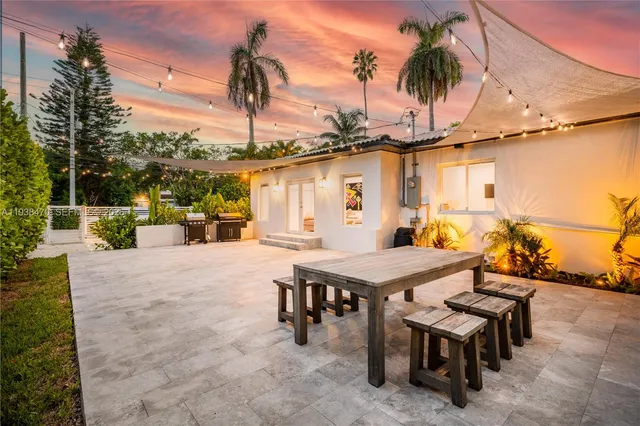 a view of a patio with a table and chairs