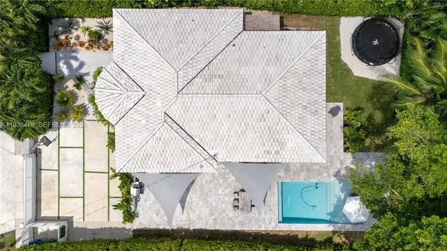 an aerial view of a house with a swimming pool