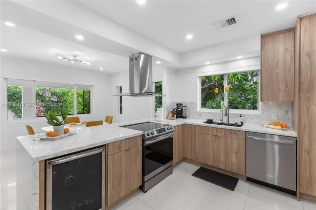 a kitchen that has a sink and a stove in it