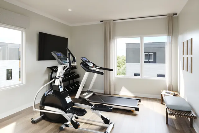 a room with gym equipment and a large window