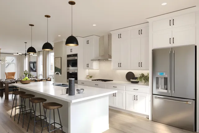 a kitchen with refrigerator and chairs