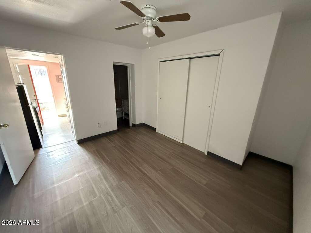 396 North E Avenue Douglas, AZ 85607 - Photo 4 of 14 a view of an empty room with wooden floor and a window