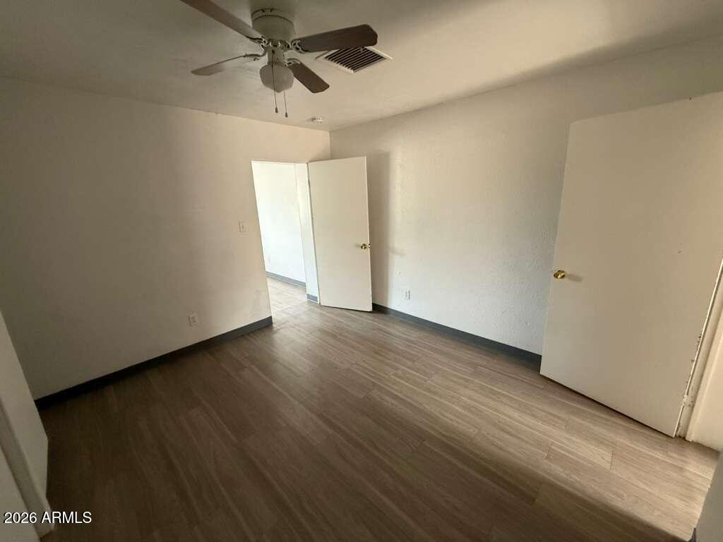 396 North E Avenue Douglas, AZ 85607 - Photo 5 of 14 a view of a room with wooden floor and white walls