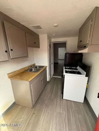 a kitchen with wooden cabinets and white appliances