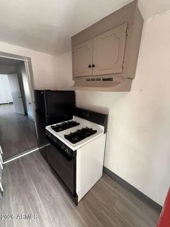 a stove top oven sitting inside of a kitchen