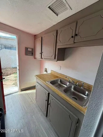 a kitchen that has a sink and a stove