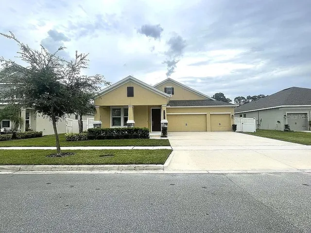 a front view of house with yard and green space