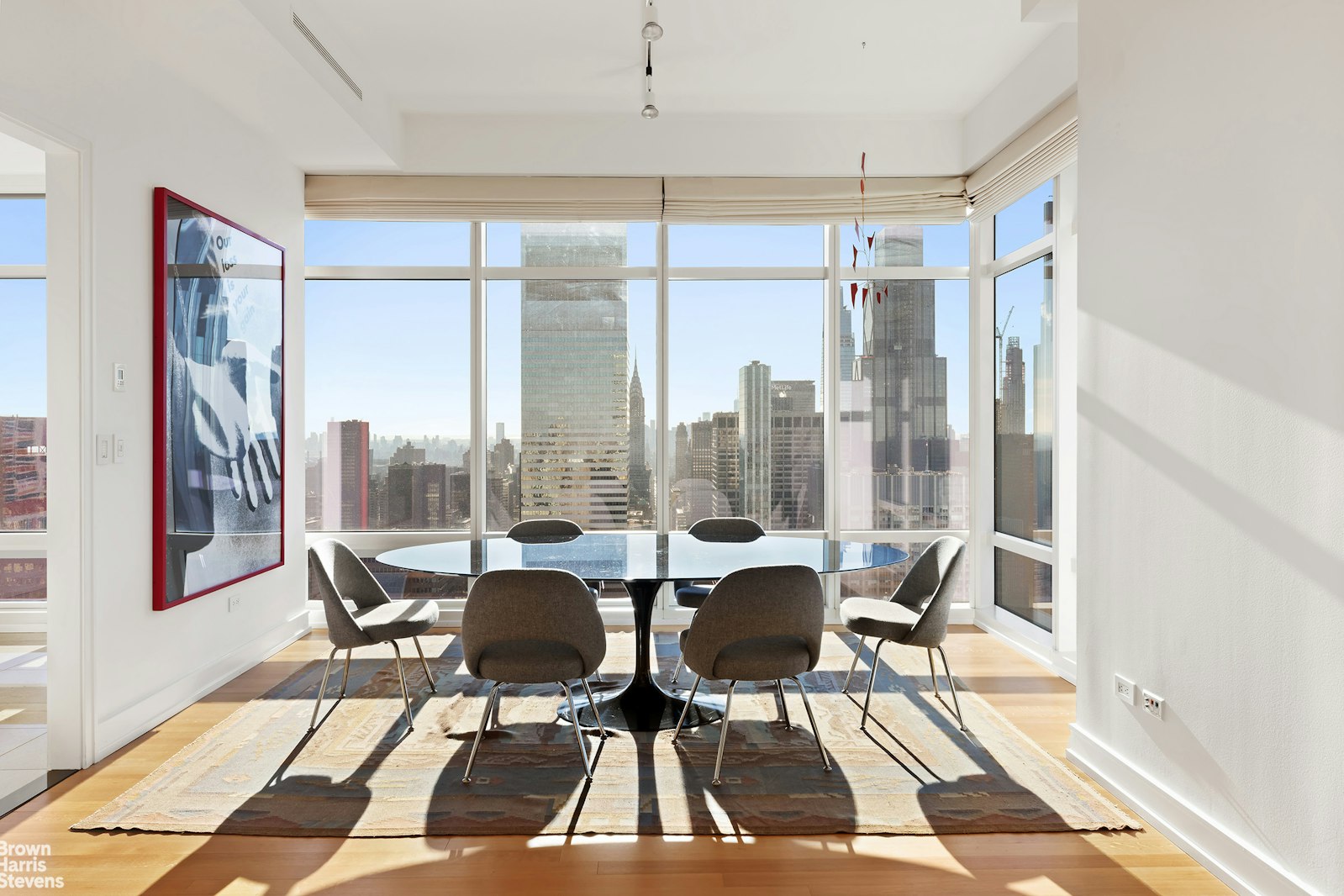 151 East 58th Street, Unit 43E Manhattan, NY 10022 - Photo 30 of 50 a living room with furniture and a floor to ceiling window
