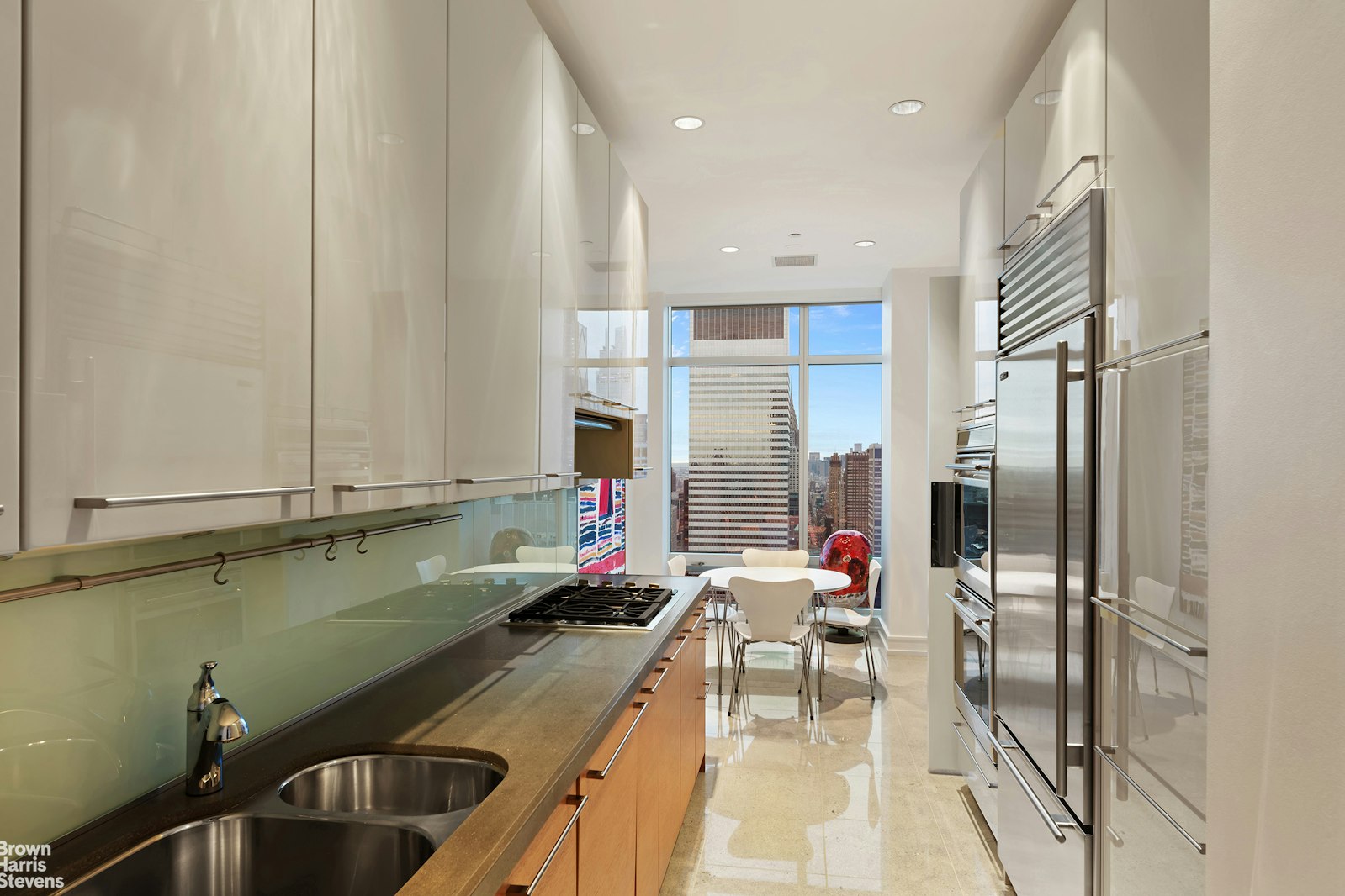 151 East 58th Street, Unit 43E Manhattan, NY 10022 - Photo 33 of 50 a kitchen with a sink dishwasher a refrigerator and cabinets