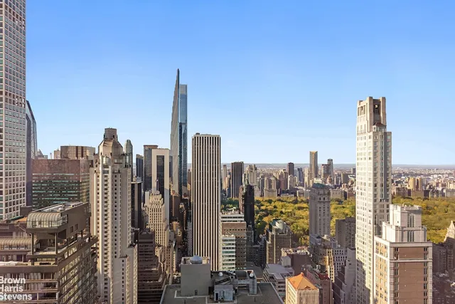 a living room with furniture and large windows