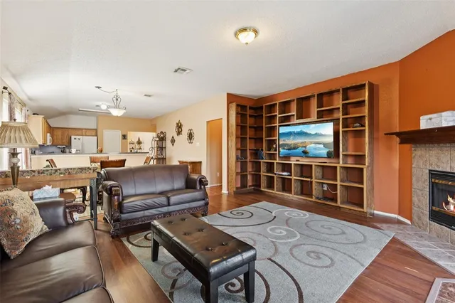 a living room with furniture a flat screen tv and a table
