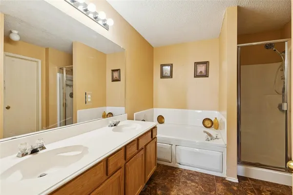 a bathroom with a tub sink and mirror