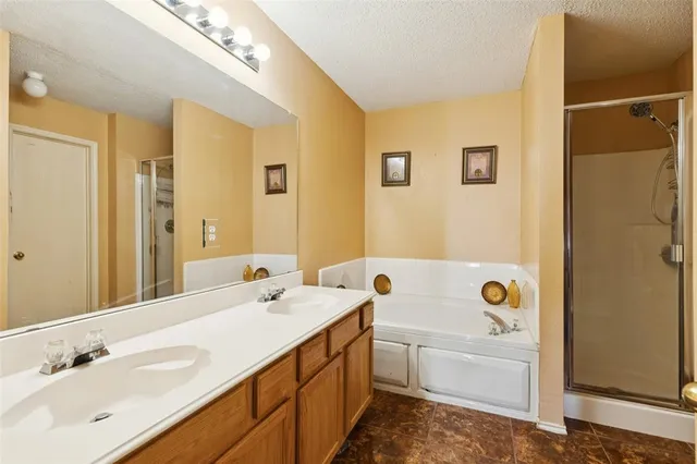a bathroom with a tub sink and mirror