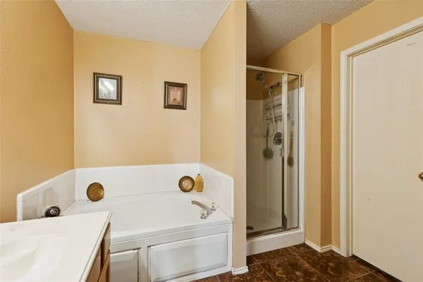 a view of a backyard with a garden and wooden fence
