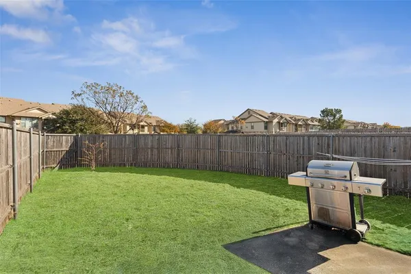 a view of a house with backyard and porch