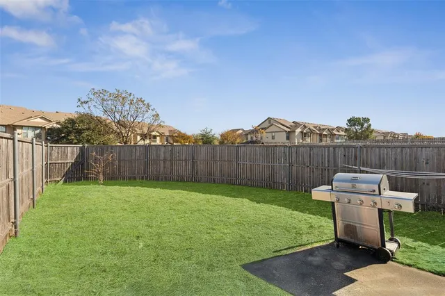 a view of a house with backyard and porch