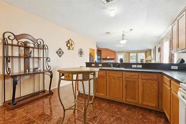 a large kitchen with a table and chairs