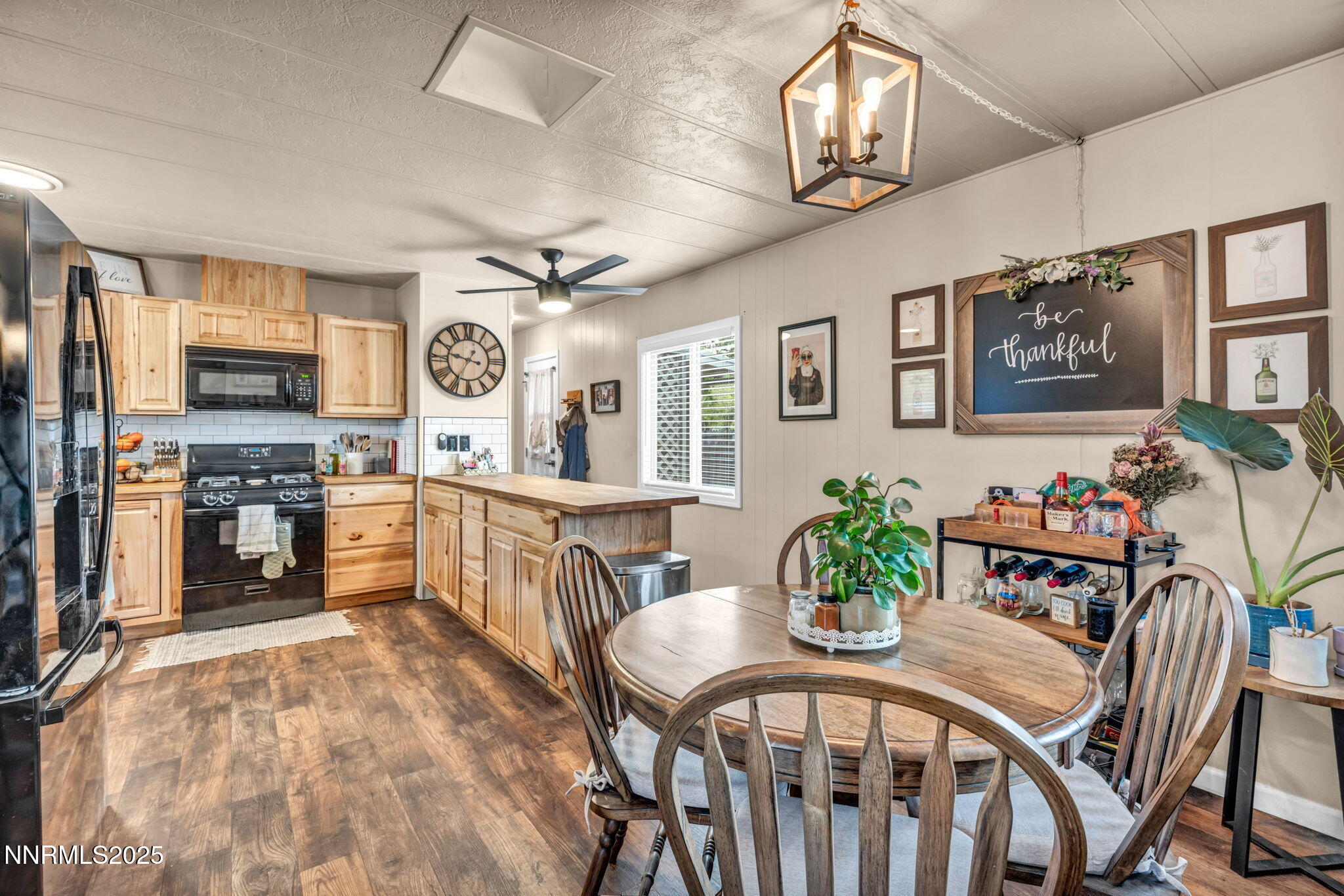 16260 Rhyolite Circle Reno, NV 89521 - Photo 13 of 18 a kitchen with stainless steel appliances granite countertop a stove a sink dishwasher a dining table and chairs with wooden floor