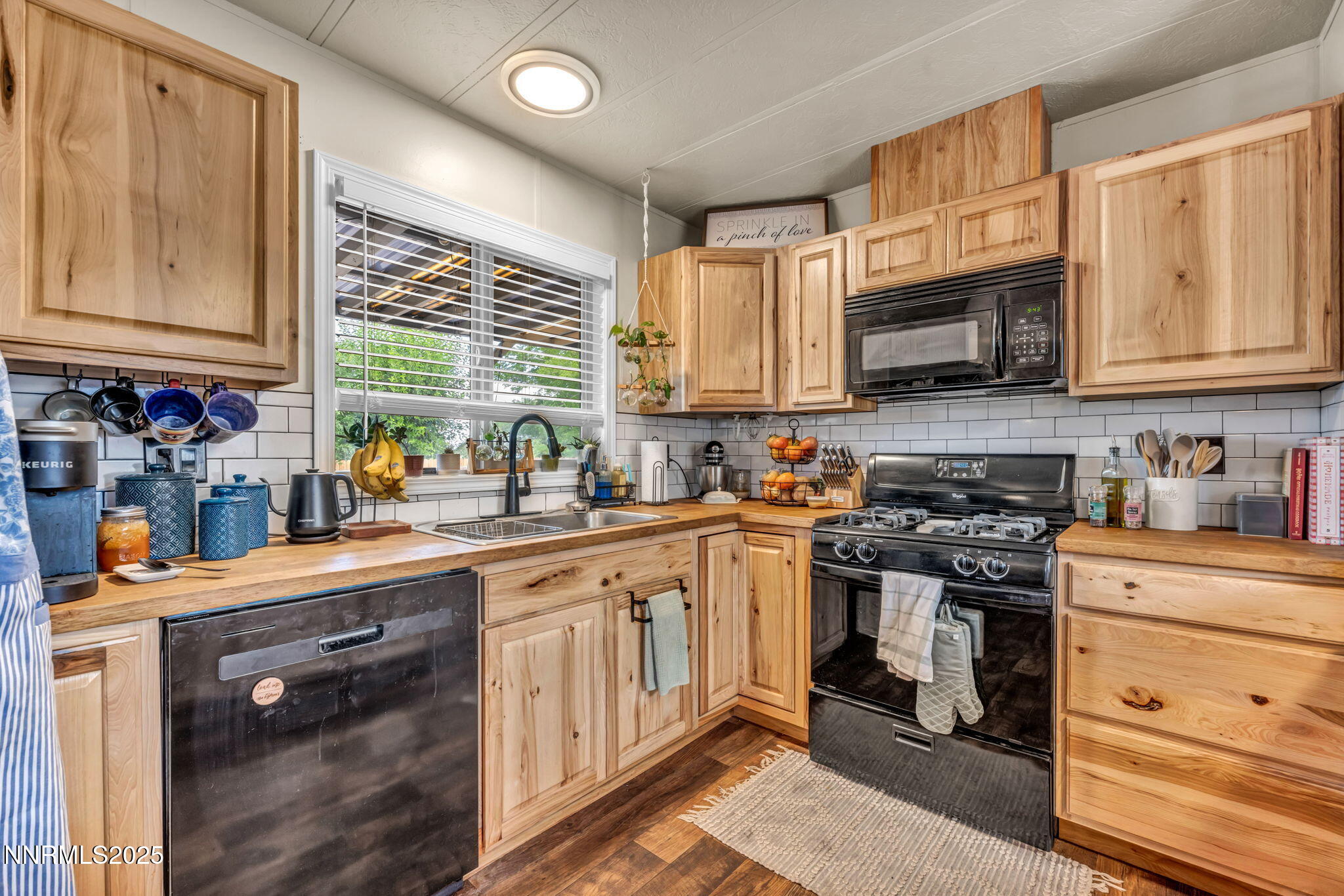 16260 Rhyolite Circle Reno, NV 89521 - Photo 3 of 18 a kitchen with stainless steel appliances granite countertop a stove sink microwave and cabinets