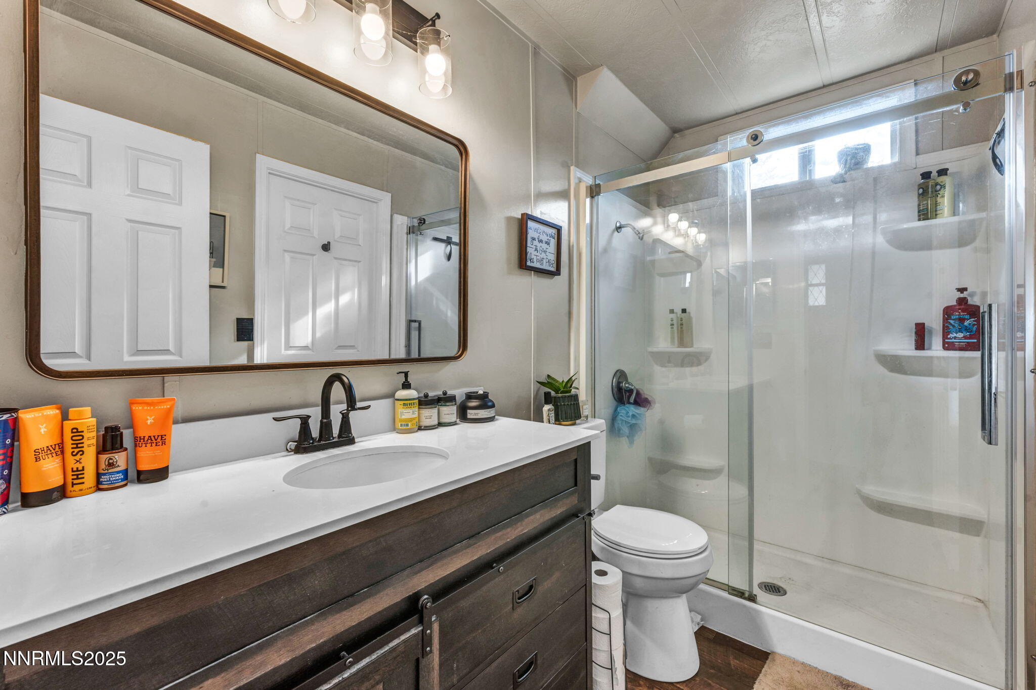 16260 Rhyolite Circle Reno, NV 89521 - Photo 8 of 18 a bathroom with a sink a toilet and shower