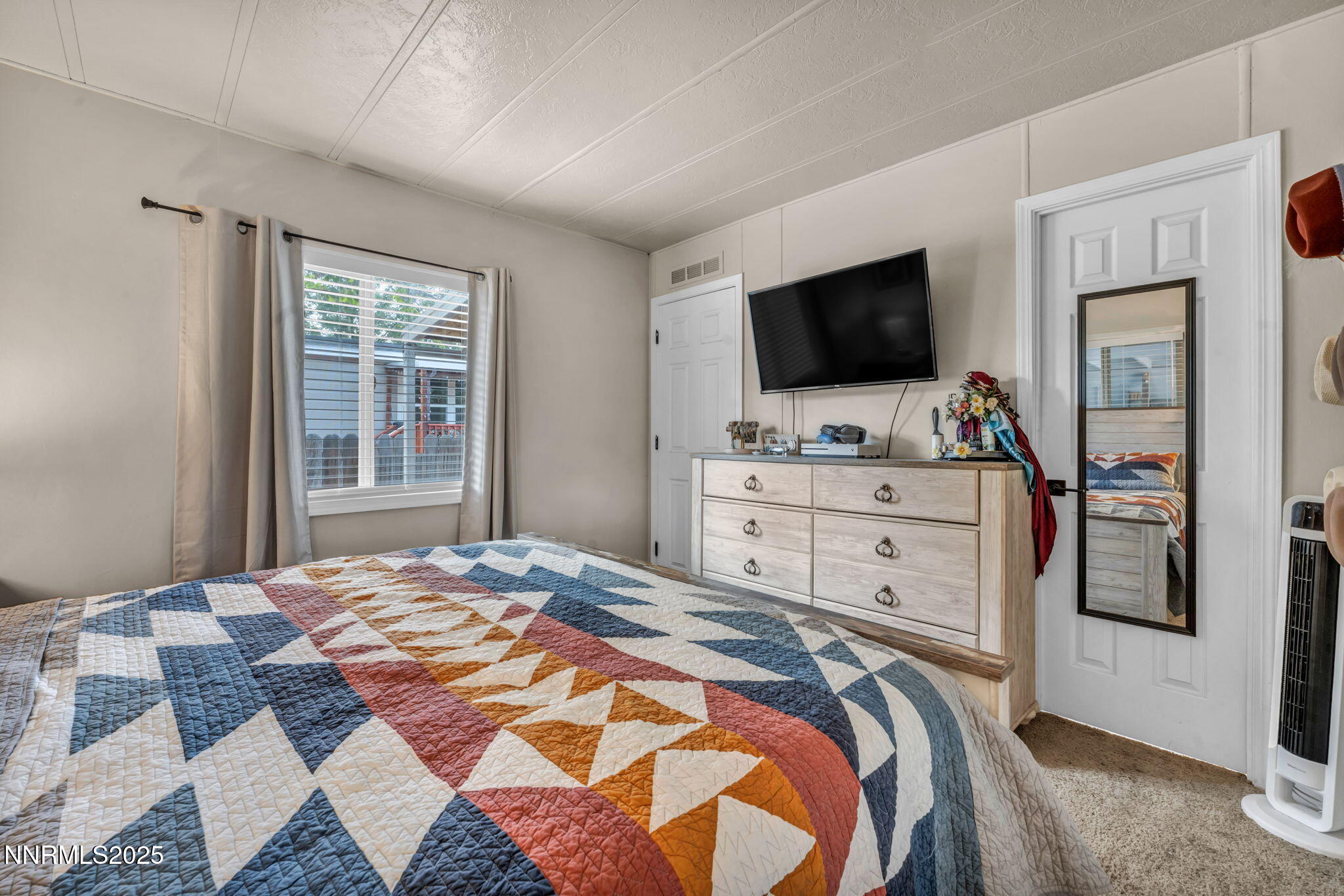 16260 Rhyolite Circle Reno, NV 89521 - Photo 10 of 18 a bedroom with a bed and a television