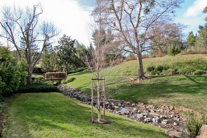 23030 Stonebridge Cupertino, CA 95014 - Photo 11 of 14 a view of a backyard with large trees