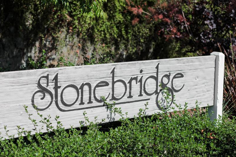 23030 Stonebridge Cupertino, CA 95014 - Photo 2 of 14 a sign on a wall with a tree in the background