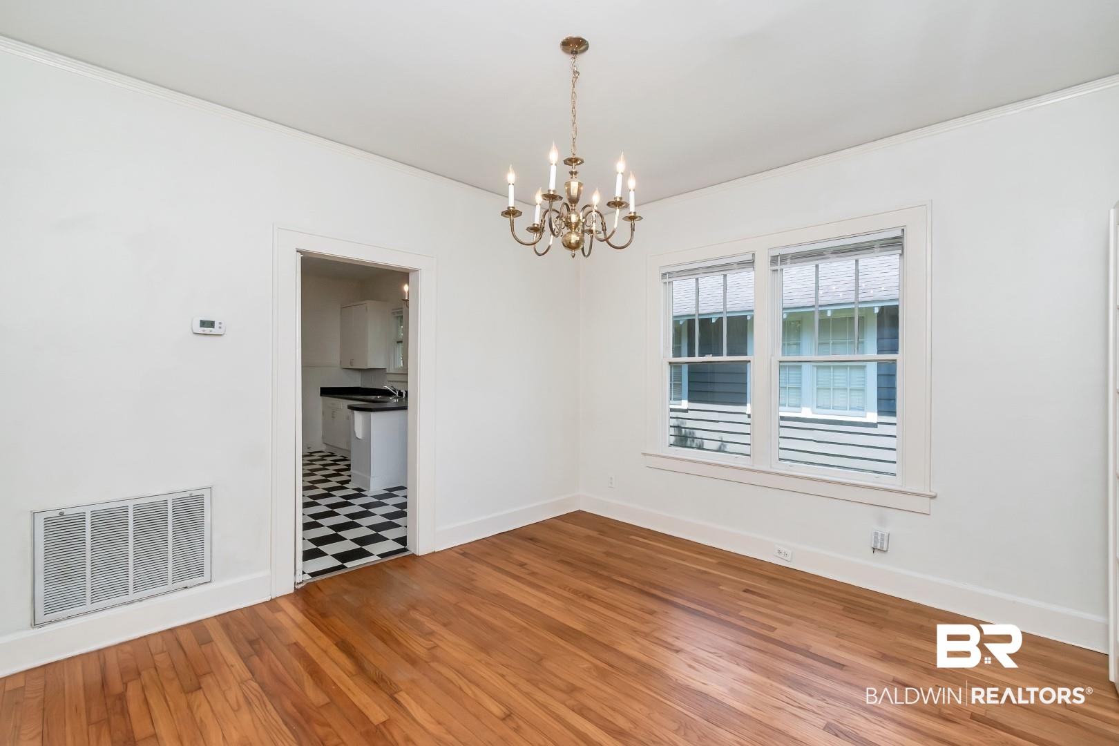 112 South Fulton Street Mobile, AL 36606 - Photo 9 of 35 Spare room featuring hardwood / wood-style flooring and a chandelier